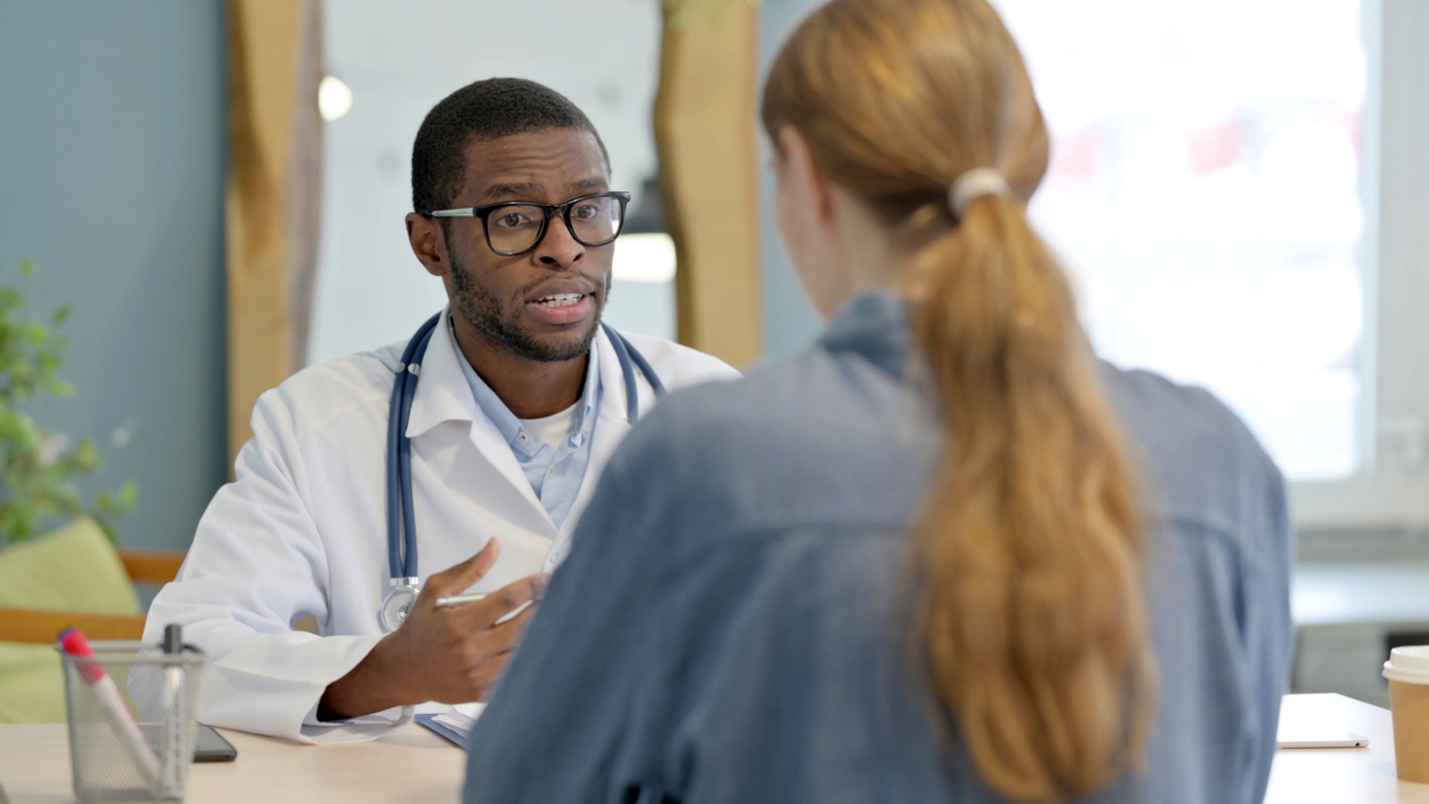 A doctor explaining what is codeine and explaining safety precautions to a patient in a medical office
