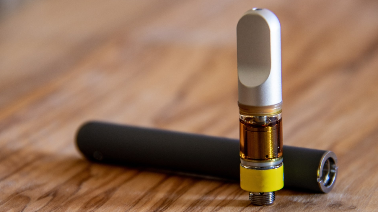 Golden amber botanical oil inside a premium weed vape cartridge from a trusted online supplier