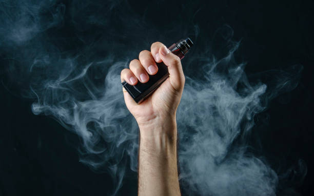 Premium style thc vapes uk vaporizing device held against a blurred city background