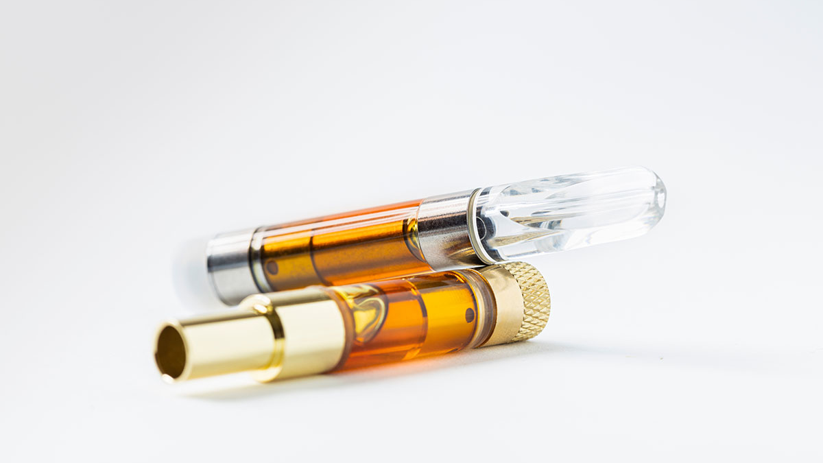 Golden organic oil inside a premium thc vape pen showing pure distillate