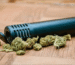 Premium style thc vapes uk vaporizing device held against a blurred city background