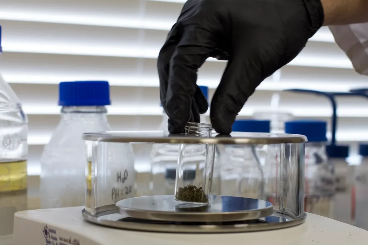 Premium bottle of pure thc p distillate resting on a modern laboratory testing table