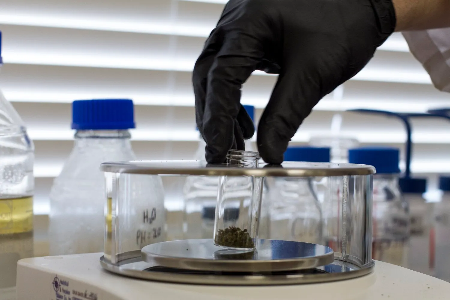 Premium bottle of pure thc p distillate resting on a modern laboratory testing table